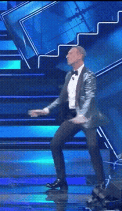 Man In Suit Dancing On Stage GIF