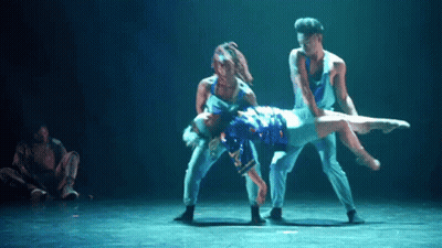 Man In Suit Dancing On Stage While Another Man Looks On GIF