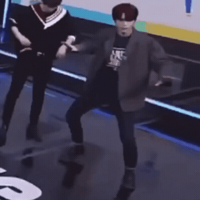 Man In Suit Dancing On Stage While Another Man Looks On GIF