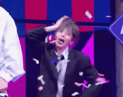 Man In Suit Dancing On Stage With Confetti GIF