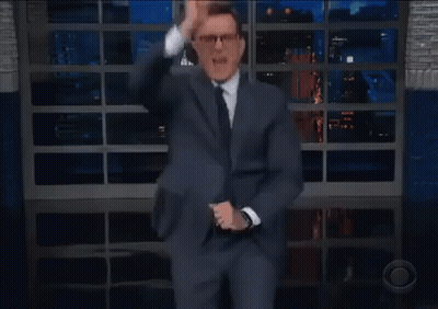 Man In Suit Dancing On Stage With Glass Wall GIF