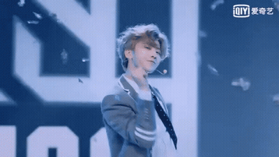Man In Suit Dancing On Stage With Microphone GIF