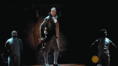 Man In Suit Dancing On Stage With Sunflower GIF