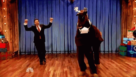 Man In Suit Dancing With Reindeer GIF