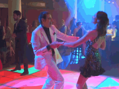 Man In Suit Dancing With Woman In Dress On Dance Floor GIF