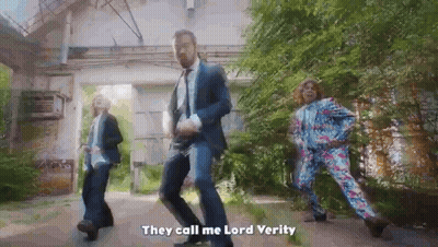 Man In Suit Dancing With Woman In Floral Pants Lord Verity GIF