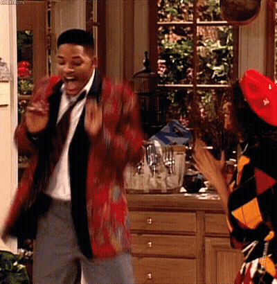Man In Suit Dancing With Woman In Red Hat GIF