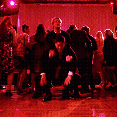 Man In Suit Doing Handstand On Another Man's Back GIF