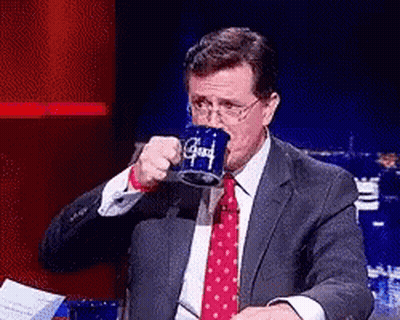 Man In Suit Drinking From Blue Mug Saying Good GIF