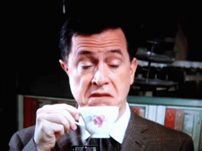 Man In Suit Drinking From Flower Cup GIF