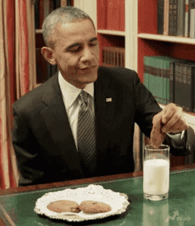Man In Suit Drinking Milk And Eating Cookies GIF