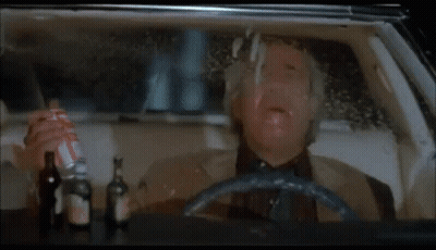 Man In Suit Driving Car At Night Making Funny Face GIF