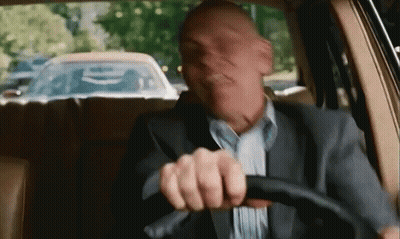 Man In Suit Driving Car Making Funny Face GIF