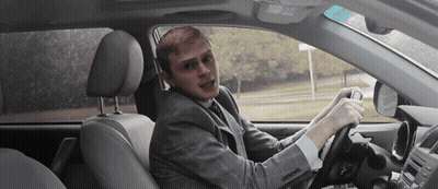 Man In Suit Driving Car Making Funny Face GIF