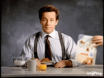 Man In Suit Eating Cereal And Drinking Orange Juice GIF