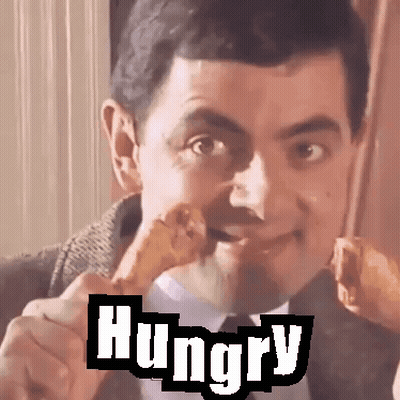 Man In Suit Eating Chicken With Hungry Behind Him GIF