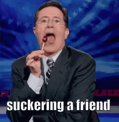 Man In Suit Eating Lollipop Suckering A Friend GIF