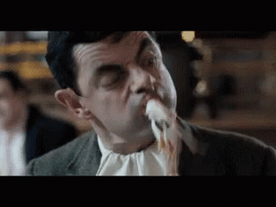 Man In Suit Eating Meat With Mouth Open GIF