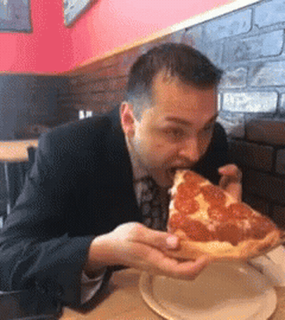Man In Suit Eating Pepperoni Pizza GIF