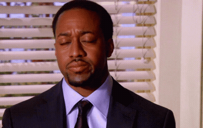 Man In Suit Eyes Closed By Window GIF