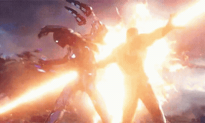 Man In Suit Fighting In Front Of Explosion GIF