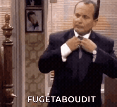 Man In Suit Fixing Tie Saying Fugetaboudit GIF