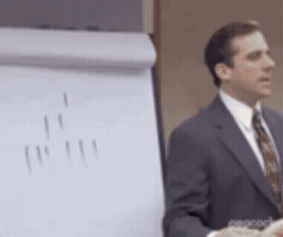 Man In Suit Giving Presentation At Whiteboard GIF