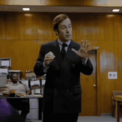 Man In Suit Giving Presentation GIF