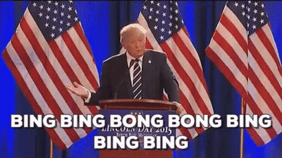 Man In Suit Giving Speech At Podium With American Flags GIF