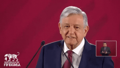 Man In Suit Giving Speech At Republica De Fifidonia Sign GIF
