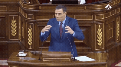 Man In Suit Giving Speech At Wooden Podium GIF