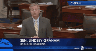Man In Suit Giving Speech In Front Of Screen Saying Sen Lindsey Graham GIF