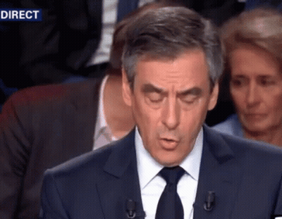 Man In Suit Giving Speech With Direct Behind GIF