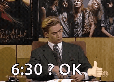 Man In Suit Giving Thumbs Up In Front Of Guns N' Roses Poster GIF