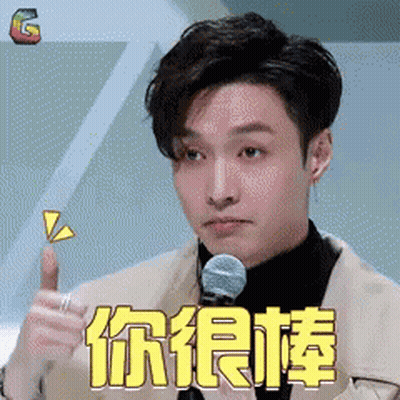 Man In Suit Giving Thumbs Up In Front Of Microphone With Chinese Writing GIF