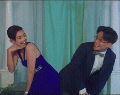 Man In Suit Giving Woman In Blue Dress Piggyback Ride GIF