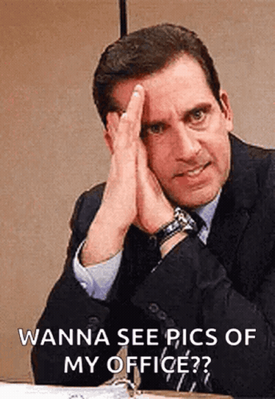 Man In Suit Hands On Face At Desk GIF