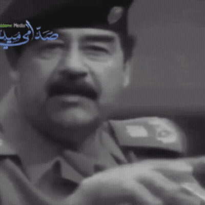 Man In Suit Hat Holding Sword Arabic News GIF