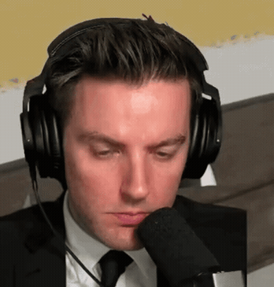 Man In Suit Headphones Talking Into Microphone GIF