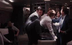 Man In Suit Held By Another In Limo GIF