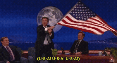 Man In Suit Holding American Flag Saying USAI USAI GIF