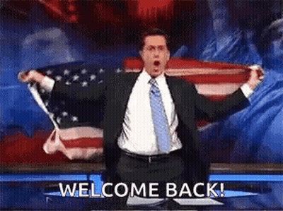 Man In Suit Holding American Flag Saying Welcome Back GIF