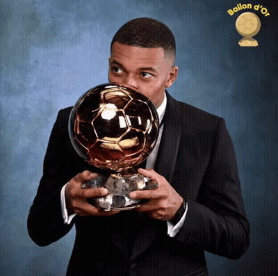 Man In Suit Holding Ballon D'Or Trophy GIF