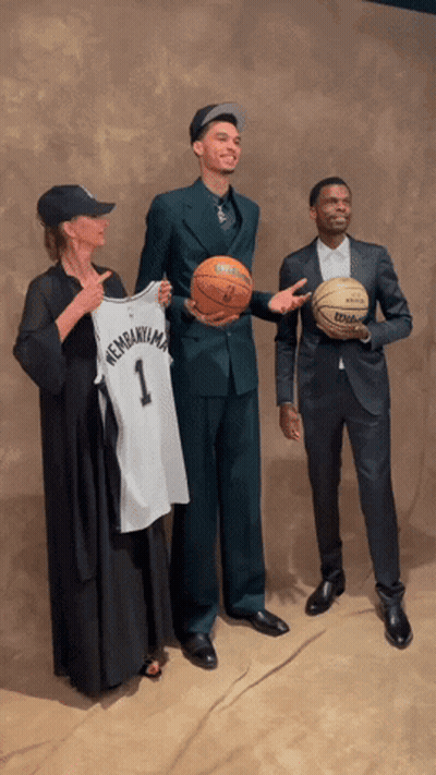 Man In Suit Holding Basketball And Jersey GIF