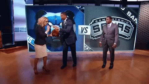 Man In Suit Holding Basketball In Front Of VS Sign GIF