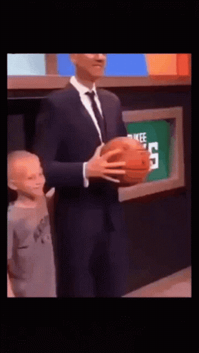 Man In Suit Holding Basketball Next To Child GIF