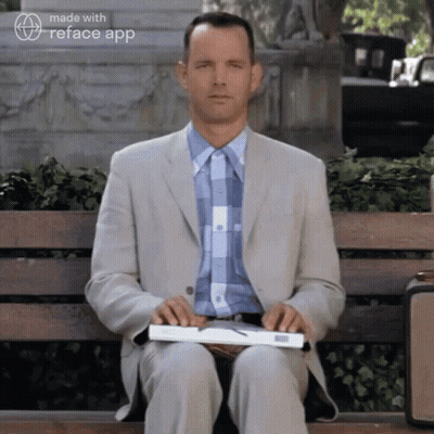 Man In Suit Holding Book On Bench GIF