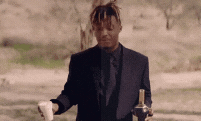 Man In Suit Holding Bottle And Coffee GIF