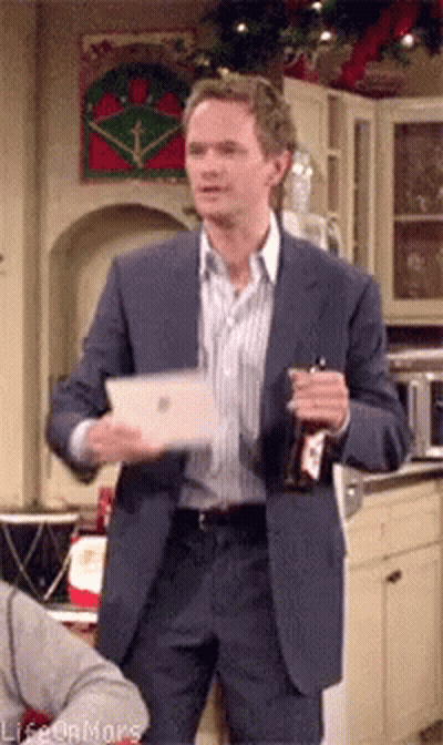 Man In Suit Holding Bottle And Tablet GIF