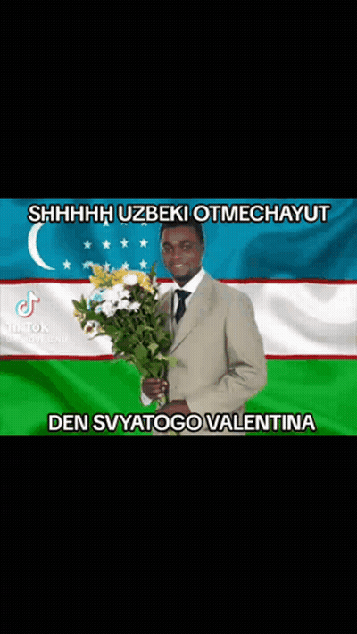 Man In Suit Holding Bouquet Of Flowers GIF
